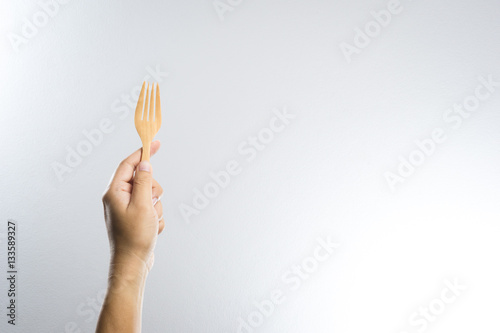 Man hand holding a wooden fork © bonnontawat