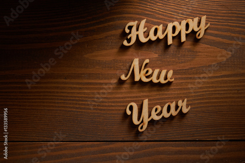 Happy New Year!/Happy New Year! - A phrase with wooden letters on a wooden backg
