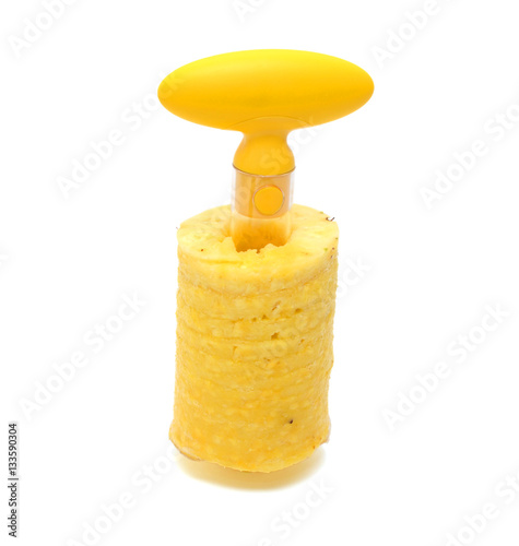Wall Mural A pineapple has been cored and sliced using a corer and slicer utensil