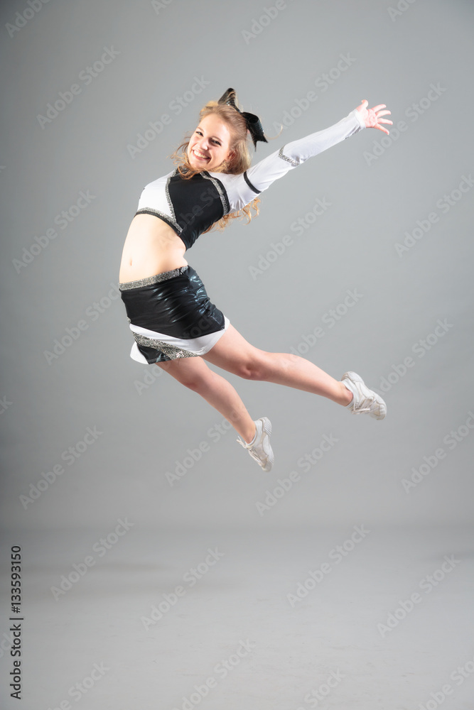 Young Cheerleader On Gray Background