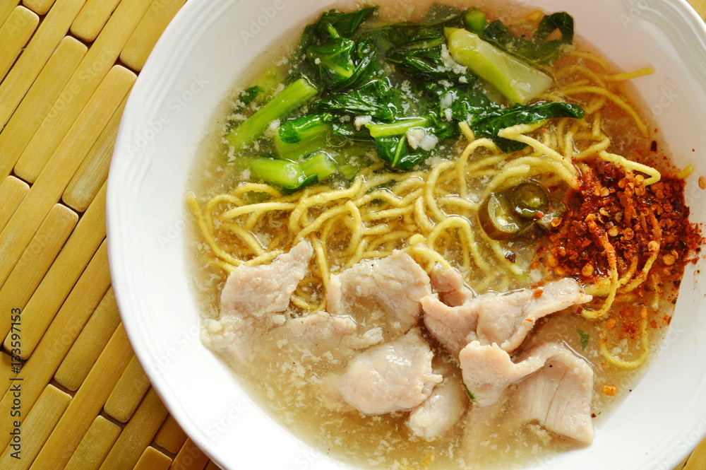 crispy fried yellow noodle with marinated pork and Chinese kale in gravy sauce crispy fried yellow noodle with marinated pork and Chinese kale in gravy sauce