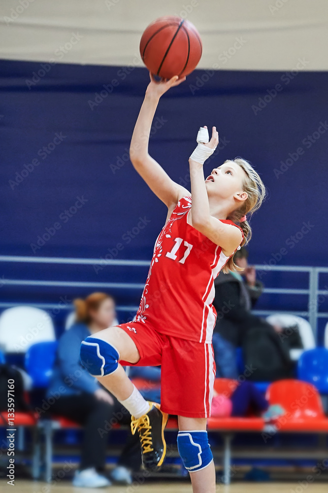 Fototapeta premium Girl athlete with injury of fingers in uniform playing basketbal