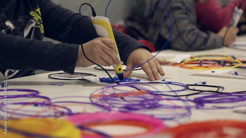 Children paint using 3D pen, melted plastic is extruded out of the pen
Children paint using 3D pen, melted plastic is extruded out of the pen
