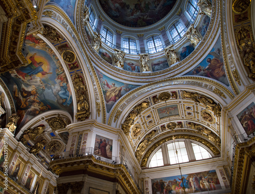 Colorful artwork and gold embellishments on the ceiling and cupola of St. Isaac s Cathedral  a Russian Orthodox Church in St. Petersburg.
