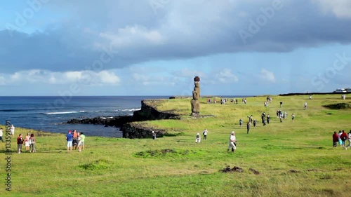 Tourists descend on Easter Island statue.