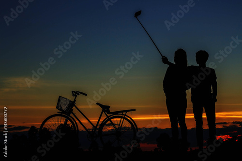 young man and girl of selfie with silhouettes.