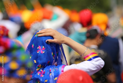 woman wearing blue veil headscarf during a gathering in the city