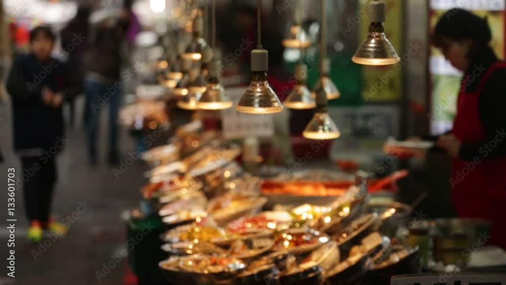 food seller prepares the dishes in Asian fish market.