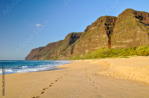 Stunning view of Polihale Beach State Park in the western part of the island of Kauai, Hawaii, USA. In the background you can see the southern end of the Na Pali Coast mountain range. No people.