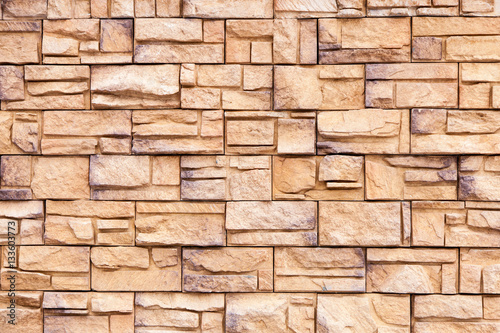 Wall from decorative beige and grey artificial slate stone. Bricks background. Stone texture. 