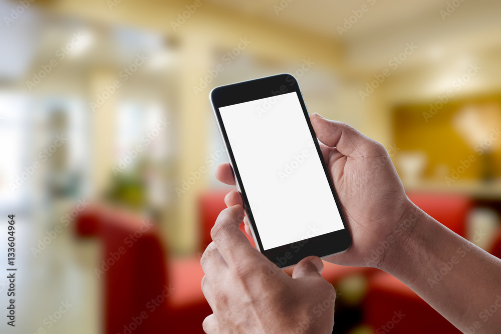 Man using mobile smartphone in living room.