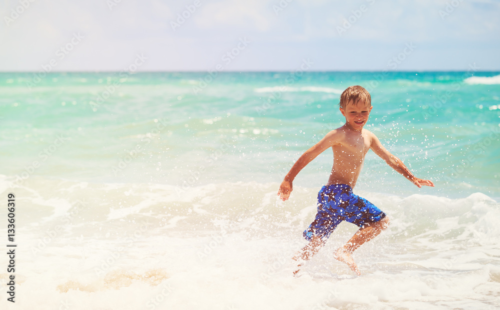happy little boy run play with waves on beach happy little boy run play with waves on beach