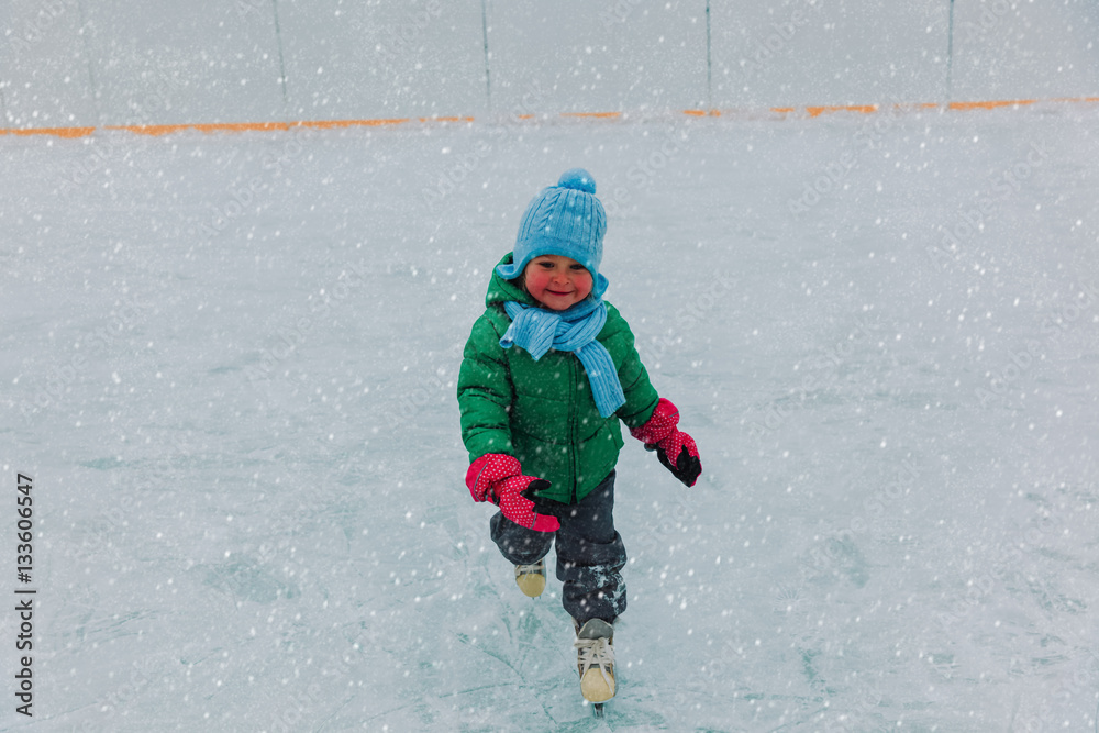 happy little girl learning to skate in winter happy little girl learning to skate in winter
