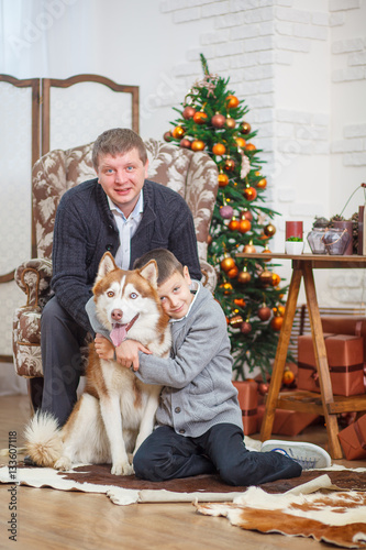 father and little boy with Husky background Christmas tree © lobodaphoto