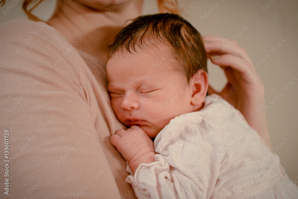Portrait of a proud loving mother holding his newborn baby daughter at home. Portrait of a newborn baby infant toddler. Close up top view portrait infant baby. Portrait of a proud loving mother holding his newborn baby daughter at home. Portrait of a newborn baby infant toddler. Close up top view portrait infant baby.