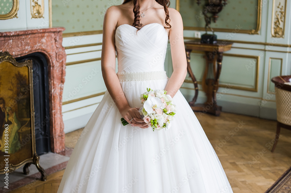 Fototapeta premium Beautiful bride with bouquet before wedding ceremony
