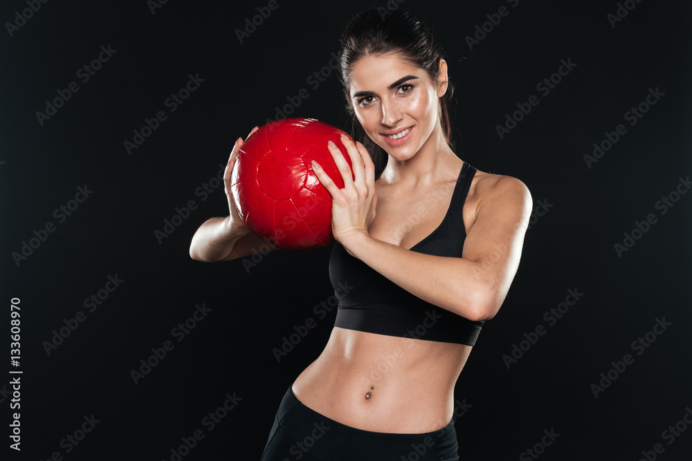 Portrait of a smiling young sports woman holding fitness ball Portrait of a smiling young sports woman holding fitness ball