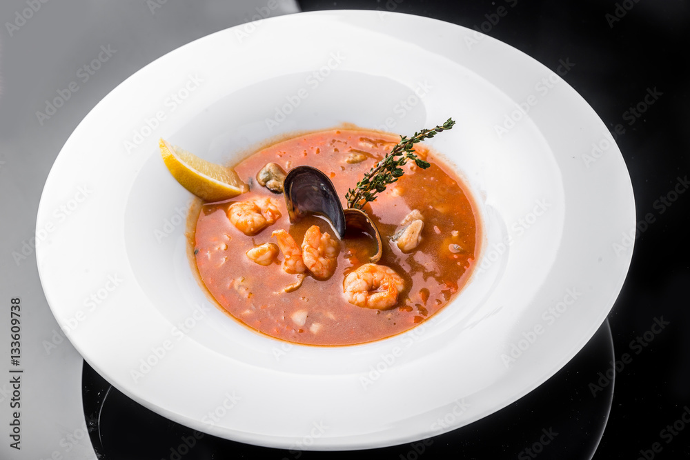French Bouillabaisse fish soup with seafood, salmon fillet, shrimp, rich taste, tasty dinner