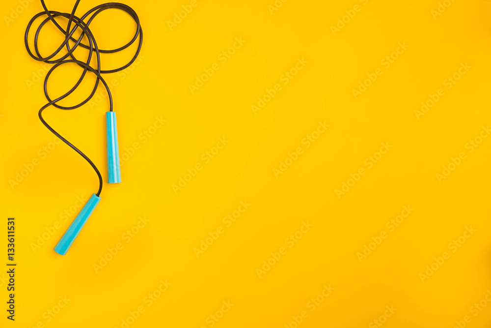 Top view of Skipping rope on yellow background Top view of Skipping rope on yellow background
