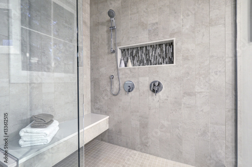 Glass walk-in shower in a bathroom of brand new home