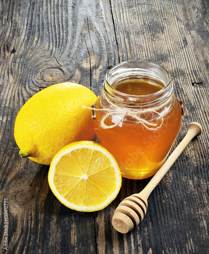 Honey and lemon on a wooden table