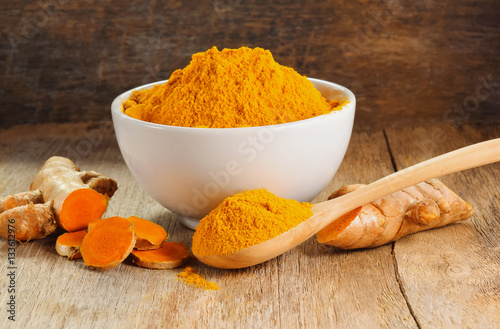 Turmeric roots with turmeric powder photo