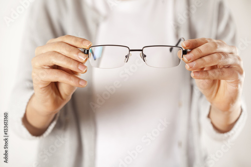 Woman hands holding eyeglasses