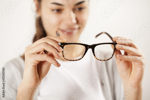 Woman hands holding eyeglasses