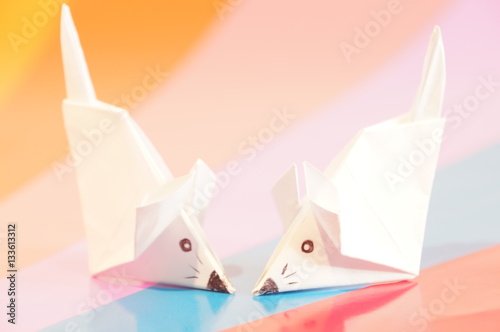 Paper origami mouse isolated on the colorful background
