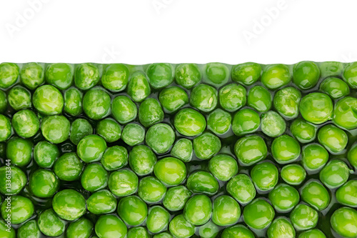 Border of wet fresh  green peas in water closeup on white background. Isolated. Healthy vitamin food. © finepoints