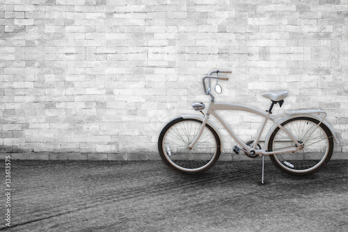Bicycle on background of old vintage White brick wall on road