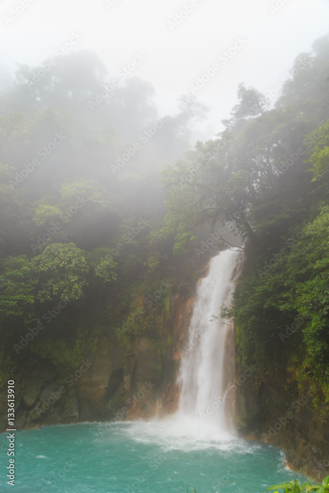 Rio celeste waterfall at foggy day Rio celeste waterfall at foggy day
