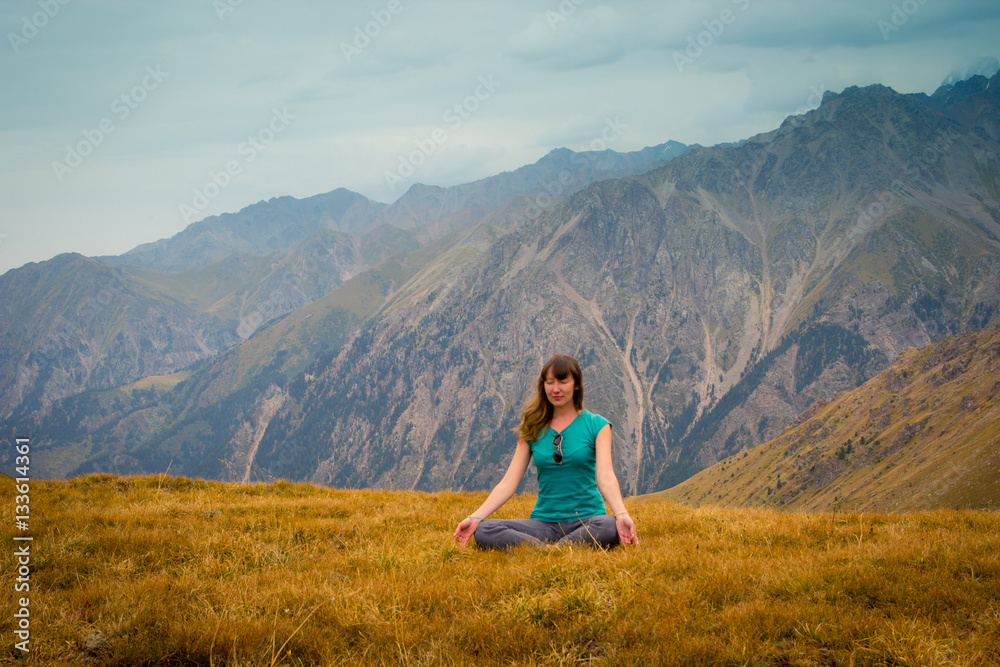 Woman are sitting in yoga style and looking into the distance at