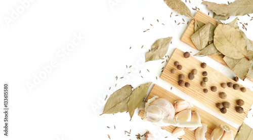 Herbs and spices selection. Top view. From above. Bay leaves, pepper and garlic on white background.
