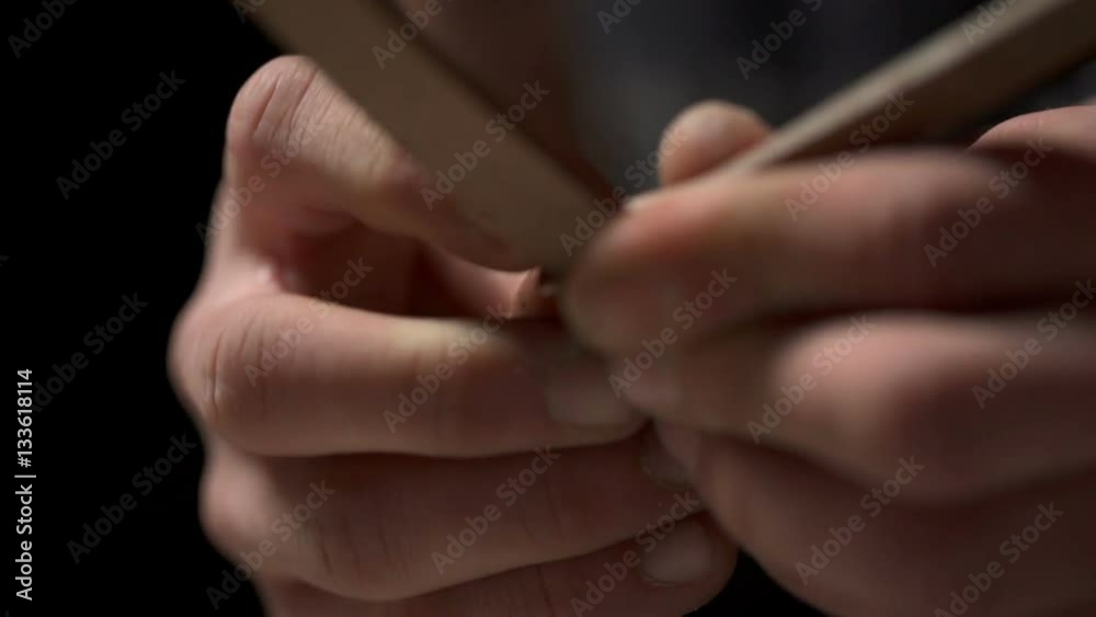 Closeup view of man's hands folding pieces of leather in the workshop Closeup view of man's hands folding pieces of leather in the workshop