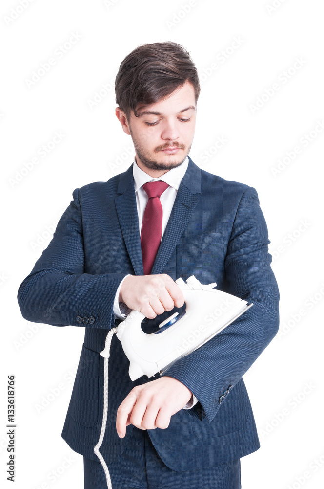 Man wearing suit holding and ironing his jacket Man wearing suit holding and ironing his jacket