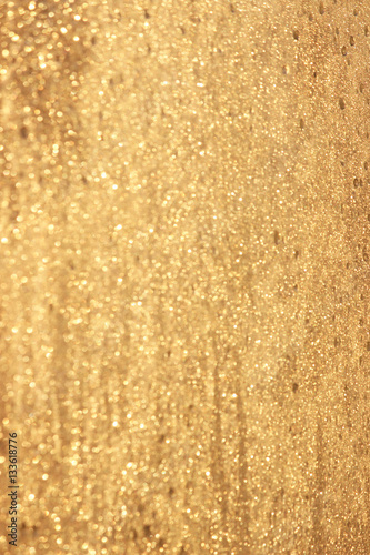 Abstract gold glitter background. Twinkled texture. Bokeh ligh