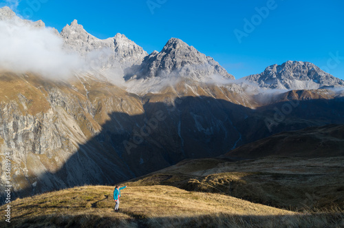 Female hiking and viewing at mountains in Allgau, Germany photo