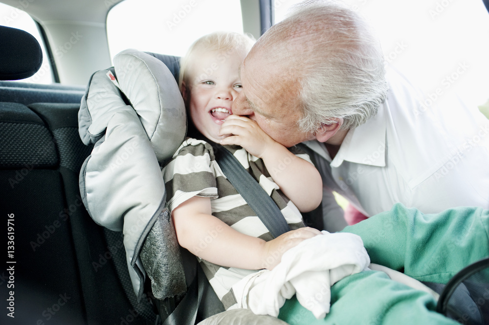 Grandfather kissing grandson in cheek Grandfather kissing grandson in cheek