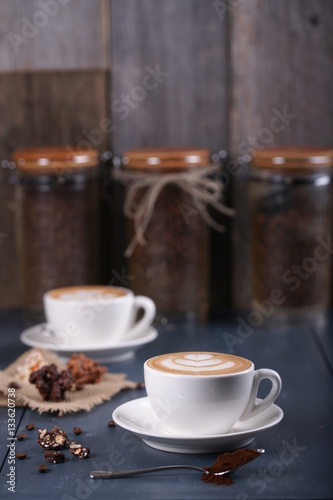 Two cups of coffee on a blue background