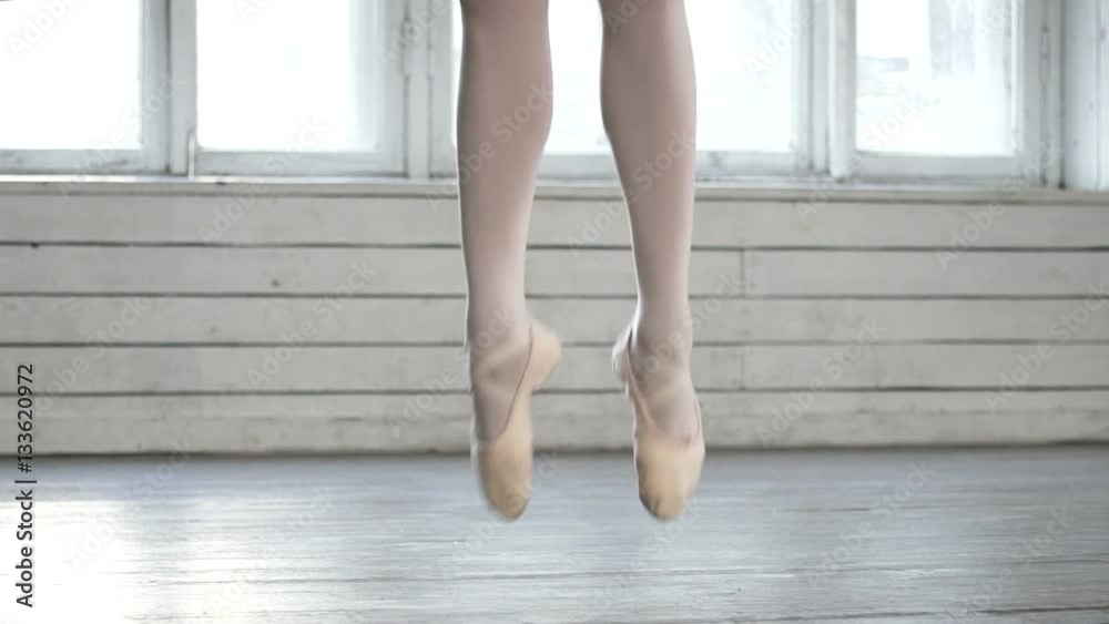 Legs of of ballerina jumping in ballet class Legs of of ballerina jumping in ballet class