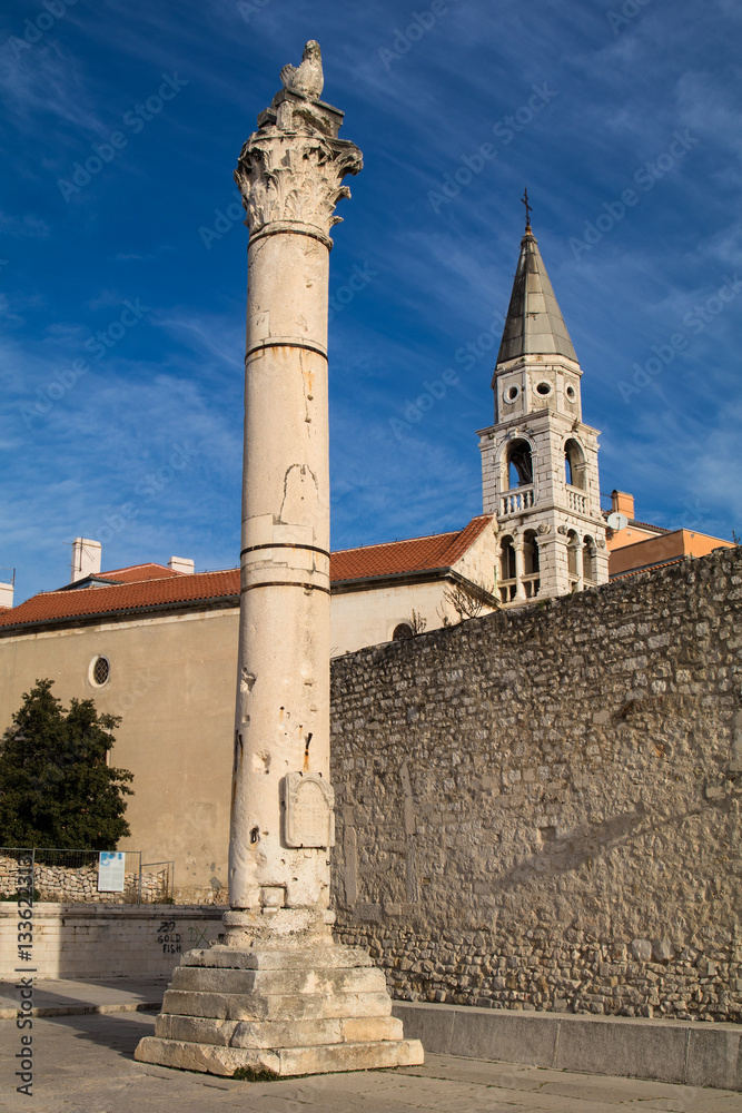 Pillar of shame and St.Elias's church on the Roma Capitolium in Zadar. Croatia.