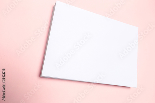 Blank paper on top of pink pastel desk