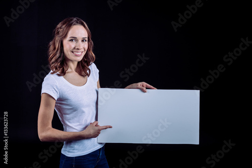 Smiling woman holding blank card