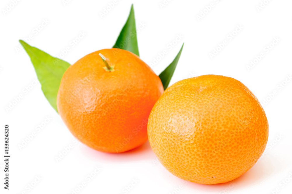 Mandarin, tangerine citrus fruit with leaves isolated on white Mandarin, tangerine citrus fruit with leaves isolated on white
