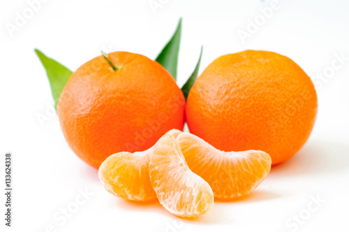 fresh orange fruits with leaf isolated on white