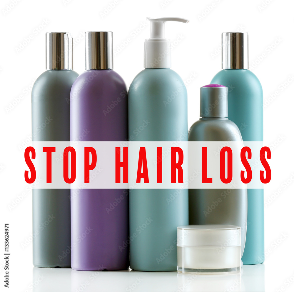 Text STOP HAIR LOSS and set of cosmetic products on white background Text STOP HAIR LOSS and set of cosmetic products on white background