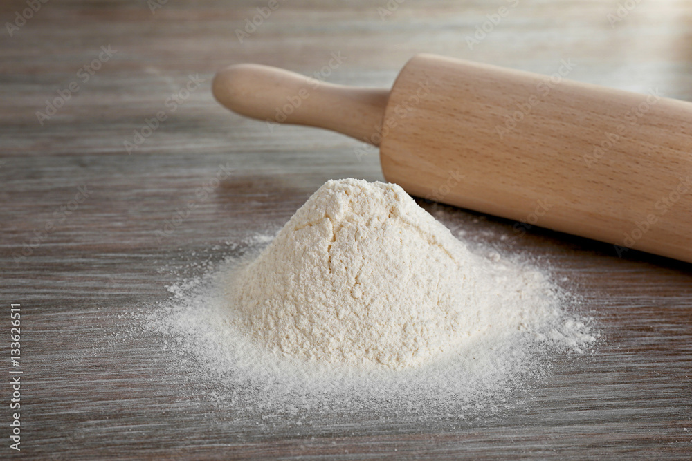 Rolling pin and flour on table Rolling pin and flour on table