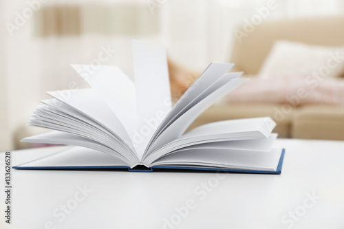 Open book on white table © Africa Studio