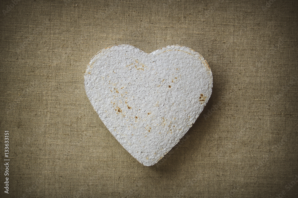 Obraz premium Heart made of paper mache on a fabric background, to be used for crafts